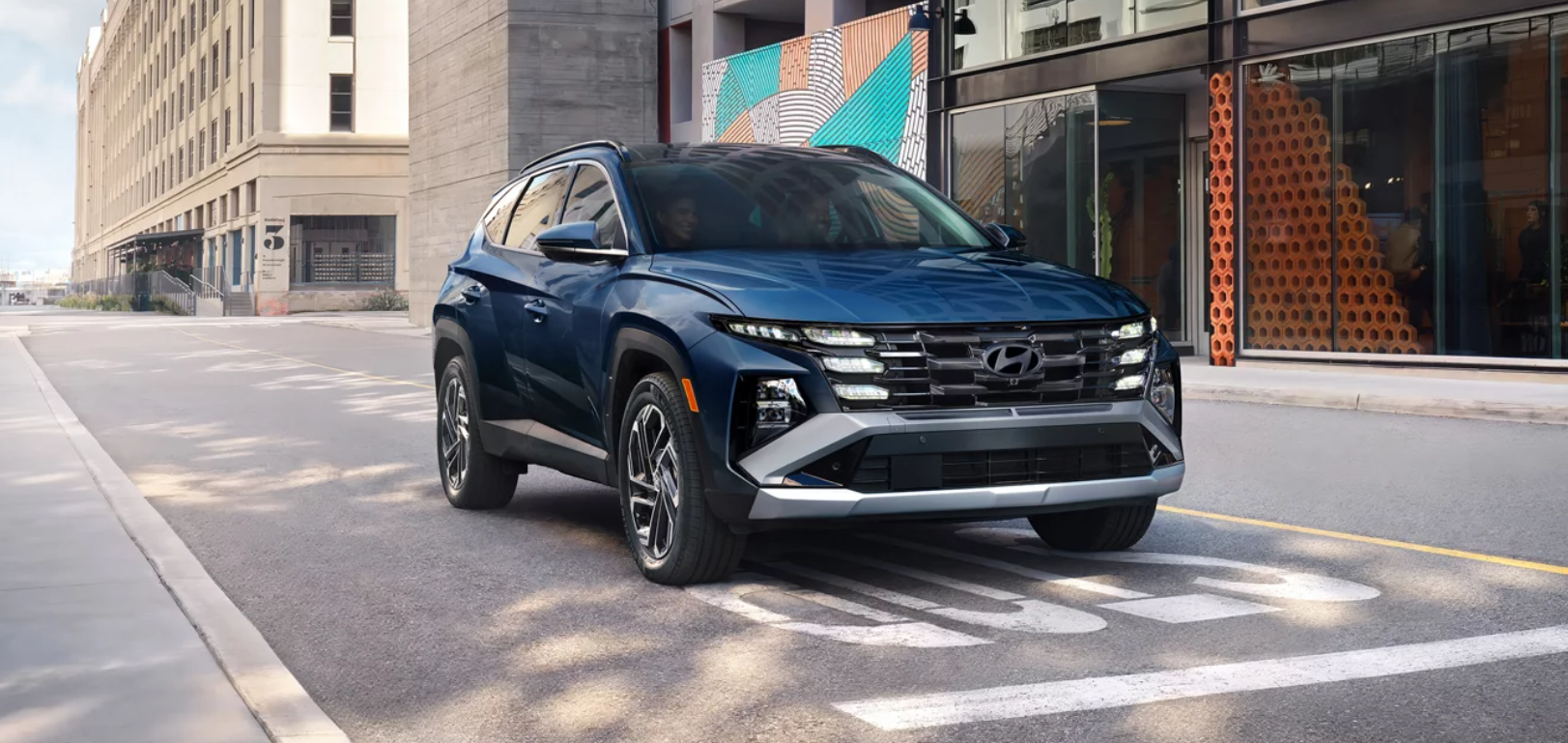 2026 Hyundai Tucson driving through city.